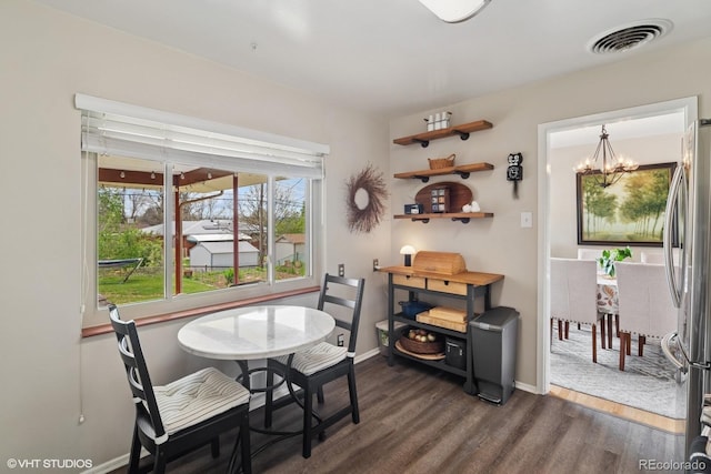 2792 S Stuart St, Denver, CO 80236 - dining room with a chandelier, dark wood finished floors, and baseboards