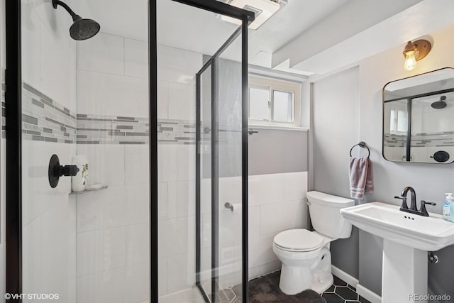 2792 S Stuart St, Denver, CO 80236 - full bathroom featuring toilet, a shower stall, a sink, and tile patterned floors
