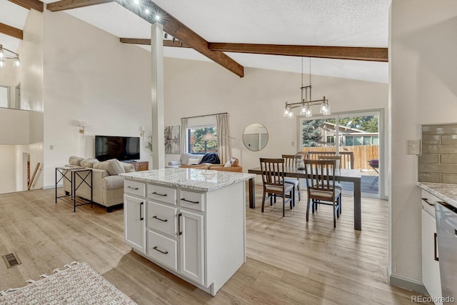 kitchen with pendant lighting, white cabinets, a chandelier, and light hardwood / wood-style floors