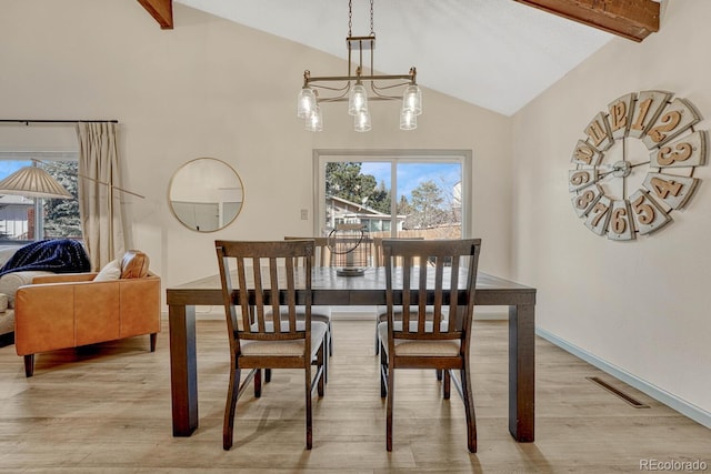 dining space featuring beam ceiling, high vaulted ceiling, a notable chandelier, and light hardwood / wood-style floors