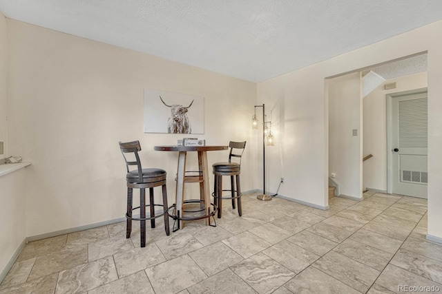 dining space with a textured ceiling