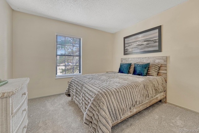 carpeted bedroom with a textured ceiling