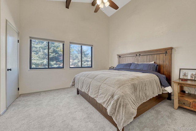 carpeted bedroom featuring ceiling fan, beam ceiling, and high vaulted ceiling