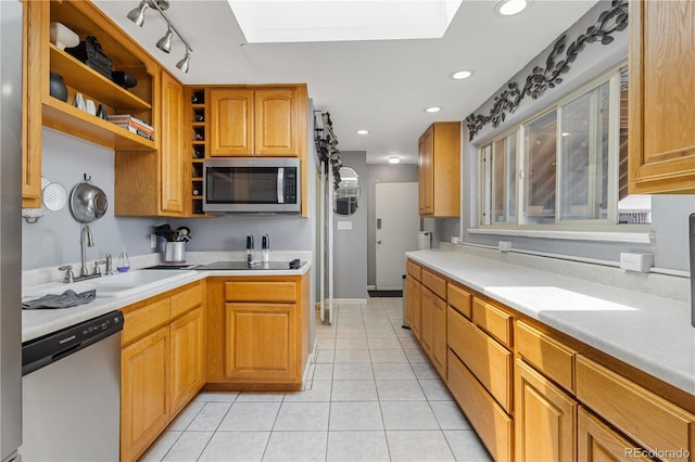 4647 W Dakota Ave, Denver, CO 80219 - kitchen with appliances with stainless steel finishes, a skylight, light countertops, light tile patterned flooring, and recessed lighting