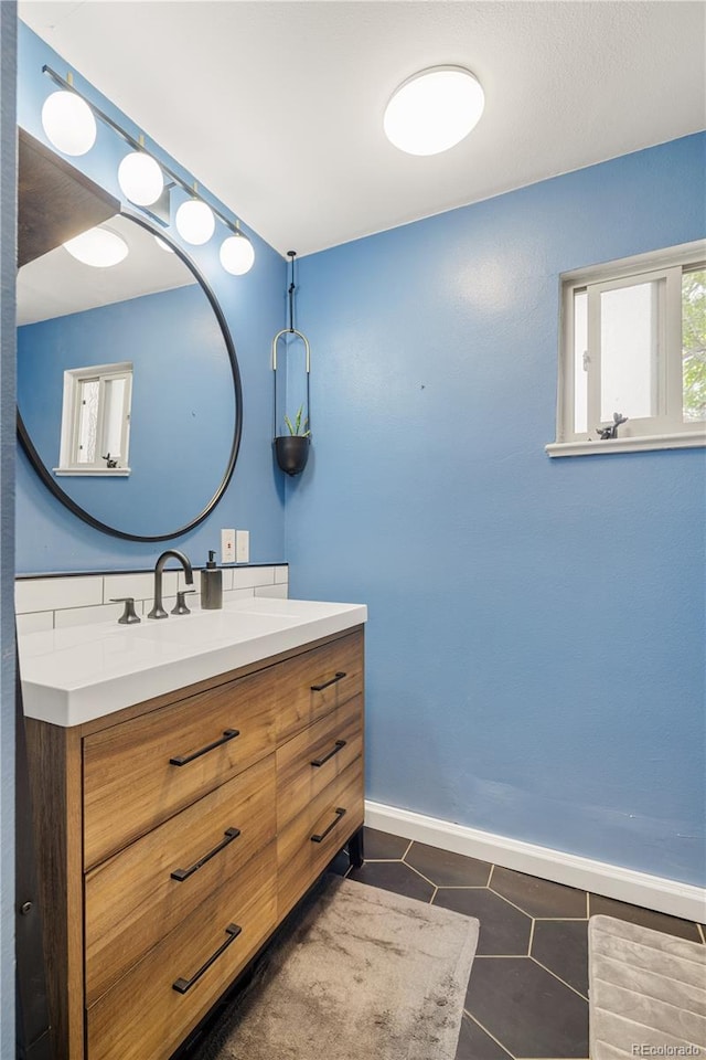 4647 W Dakota Ave, Denver, CO 80219 - bathroom with vanity and tile patterned flooring