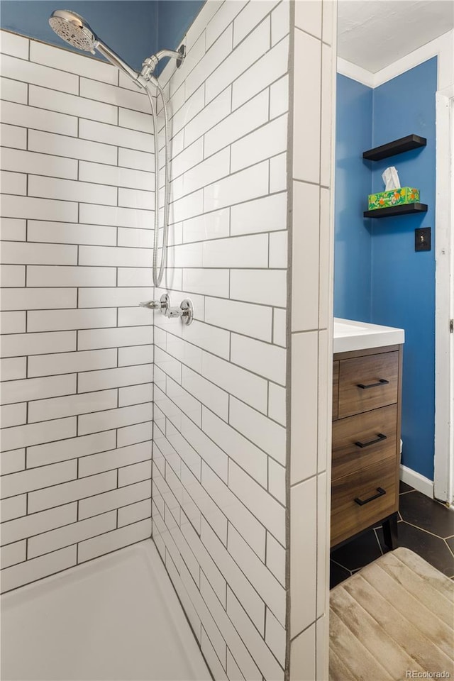 4647 W Dakota Ave, Denver, CO 80219 - bathroom featuring tiled shower and vanity