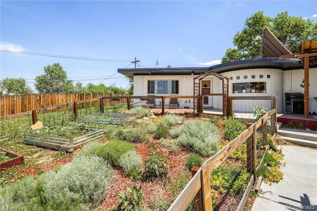 4647 W Dakota Ave, Denver, CO 80219 - back of house with a garden and roof mounted solar panels