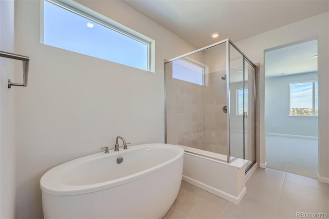 bathroom featuring a soaking tub, a shower stall, tile patterned flooring, and recessed lighting