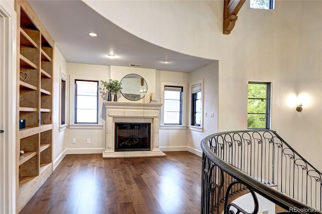 living room with wood finished floors, a wealth of natural light, and baseboards