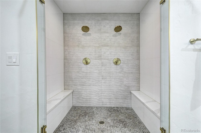 full bathroom featuring a tile shower and tile patterned flooring