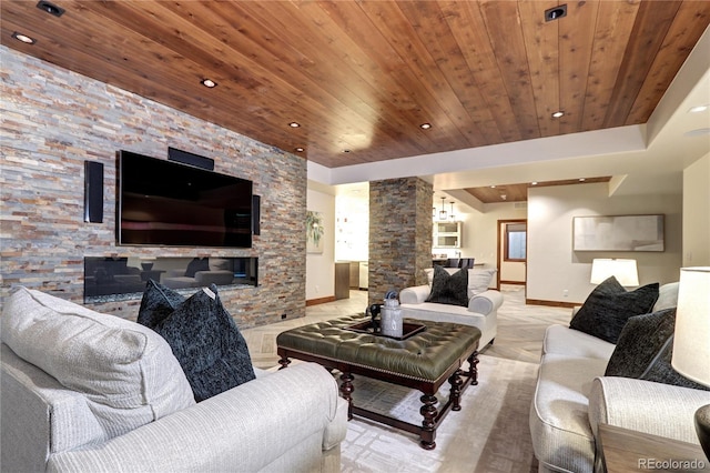 living area featuring recessed lighting, baseboards, wood ceiling, and decorative columns