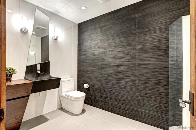 bathroom with tile patterned floors, vanity, tile walls, toilet, and recessed lighting