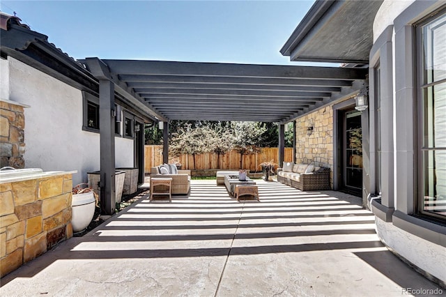 view of patio with fence and outdoor lounge area