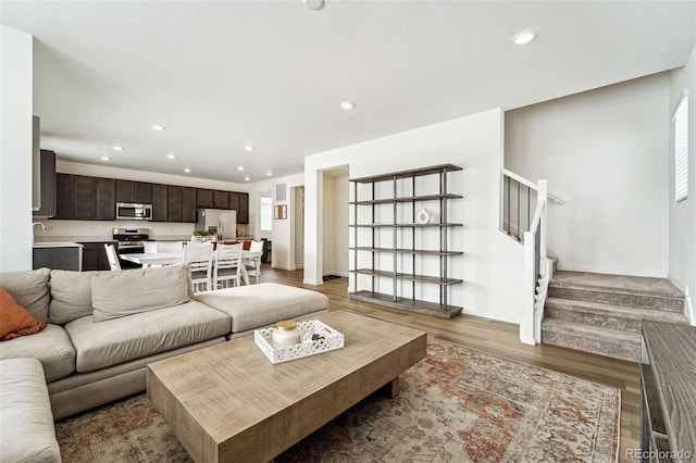 living room featuring dark hardwood / wood-style flooring and sink