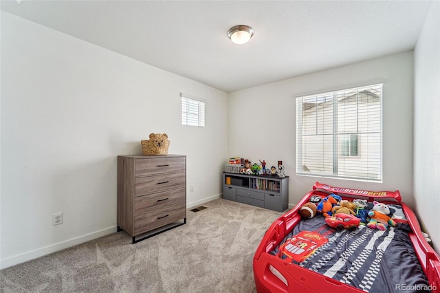 bedroom featuring multiple windows and light colored carpet