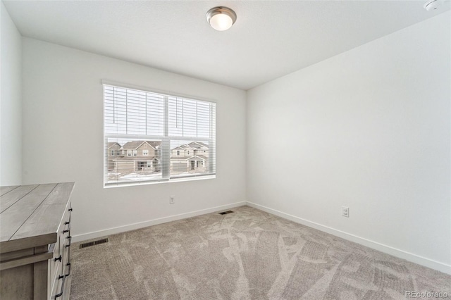 empty room featuring light carpet