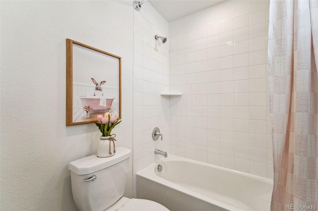 bathroom featuring shower / tub combo and toilet