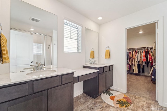 bathroom featuring vanity and a shower with door