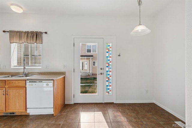 10578 Country Park Pt, Fountain, CO 80817 - kitchen featuring white dishwasher, a sink, light countertops, baseboards, and hanging light fixtures