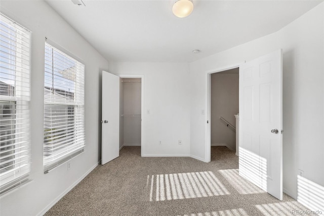 10578 Country Park Pt, Fountain, CO 80817 - unfurnished bedroom with a walk in closet, carpet flooring, baseboards, and a closet