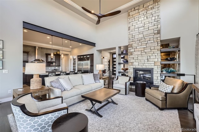 living room with dark hardwood / wood-style flooring, crown molding, and built in features