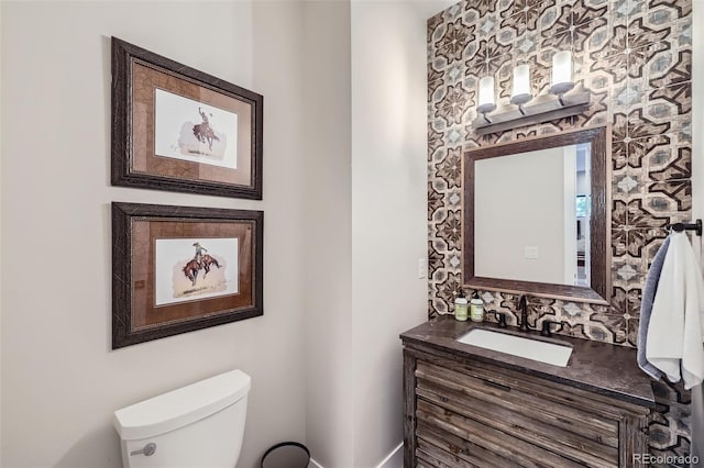 bathroom with toilet and vanity