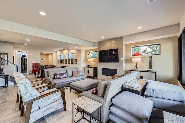 living room featuring a fireplace and light wood-type flooring