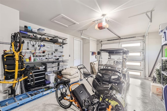 garage with a workshop area and a garage door opener