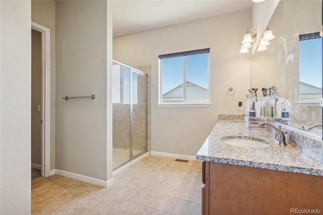 bathroom featuring vanity, a shower with door, and tile patterned floors