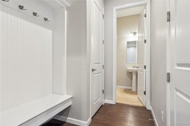 mudroom with sink and dark hardwood / wood-style flooring