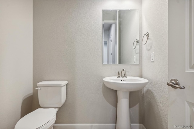 bathroom featuring sink and toilet