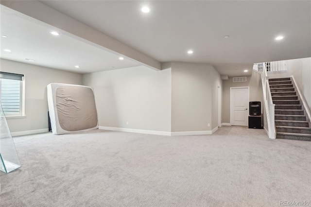 basement featuring light colored carpet