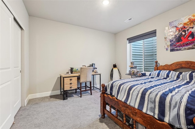 bedroom with light carpet and a closet