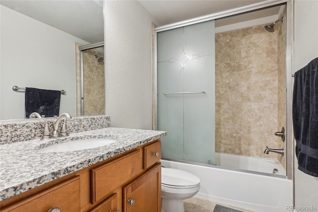 full bathroom featuring enclosed tub / shower combo, vanity, and toilet