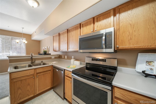 kitchen with sink, decorative light fixtures, appliances with stainless steel finishes, kitchen peninsula, and a notable chandelier