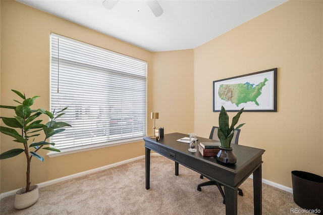 carpeted home office with ceiling fan