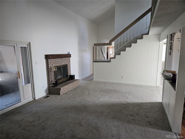 unfurnished living room featuring carpet flooring and a fireplace