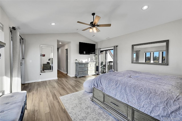 bedroom featuring multiple windows, hardwood / wood-style flooring, ceiling fan, and lofted ceiling