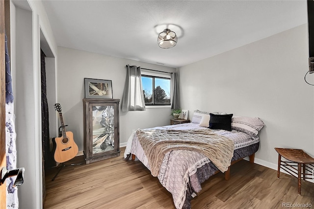 bedroom with light wood-type flooring