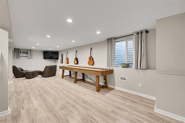 rec room with light hardwood / wood-style flooring