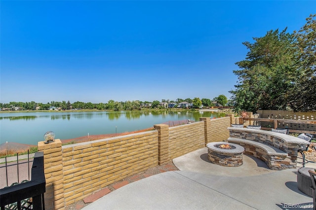 view of patio / terrace featuring a fire pit and a water view