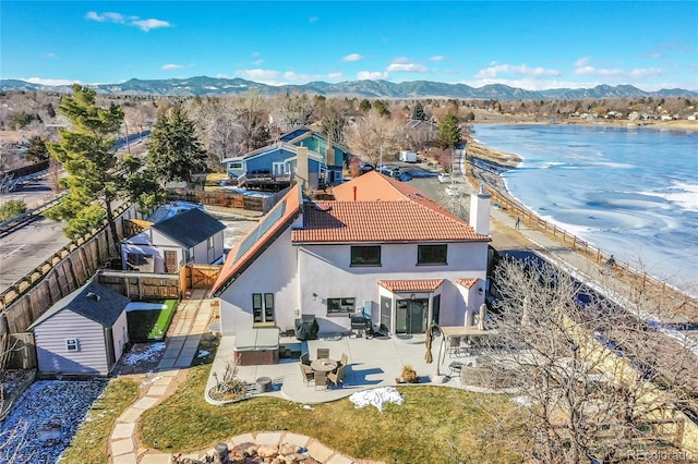 drone / aerial view with a water and mountain view