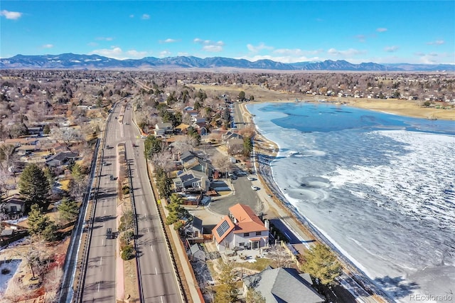 aerial view featuring a view of the beach and a water and mountain view