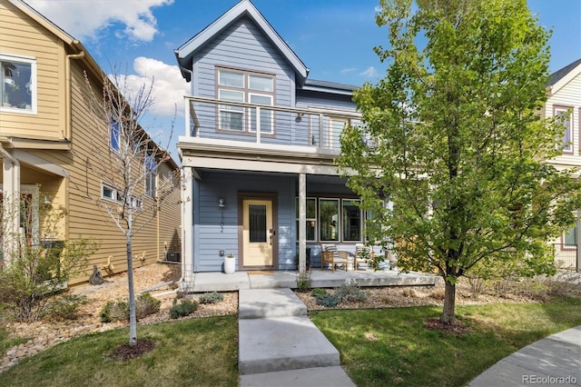 1702 W 66th Ave, Denver, CO 80221 - view of front of home featuring a porch, a balcony, and a front yard