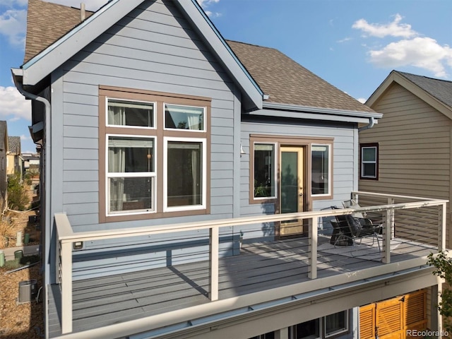 1702 W 66th Ave, Denver, CO 80221 - back of property featuring a shingled roof and a deck