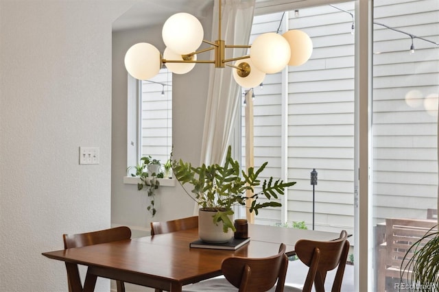 1702 W 66th Ave, Denver, CO 80221 - dining area with an inviting chandelier and a textured wall