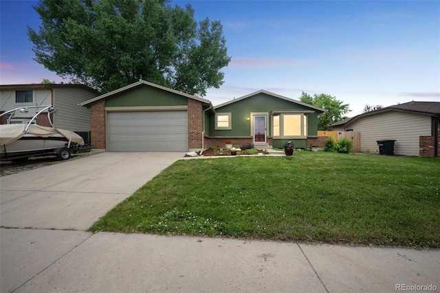 10462 Hoyt St, Westminster, CO 80021 - ranch-style house featuring a garage, a front yard, driveway, and brick siding