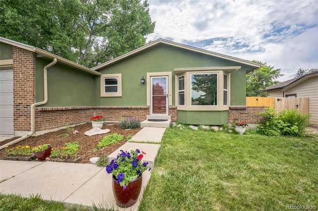 10462 Hoyt St, Westminster, CO 80021 - view of front of home featuring brick siding, stucco siding, and a garage