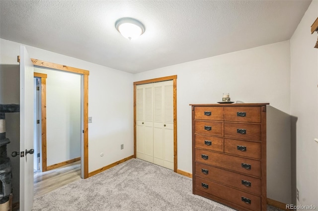 10462 Hoyt St, Westminster, CO 80021 - bedroom featuring a closet, light carpet, and a textured ceiling