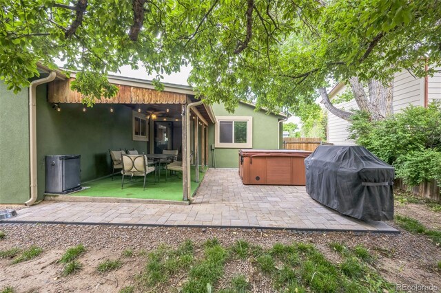 10462 Hoyt St, Westminster, CO 80021 - rear view of property with a hot tub, stucco siding, a patio area, a fenced backyard, and outdoor dining space